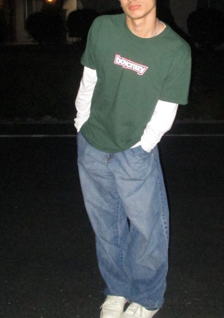 blue jeans, white long sleeve under shirt, and a green T-shirt that reads "boycrazy"