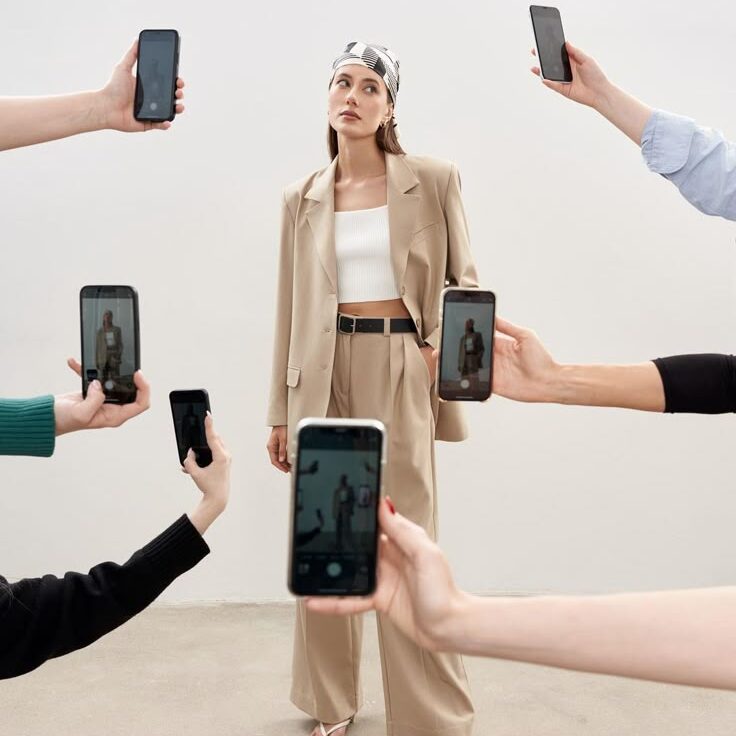 Model, people taking her picture with several phones